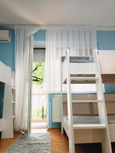 two bunk beds in a room with a window at Hostel Central Skopje in Skopje