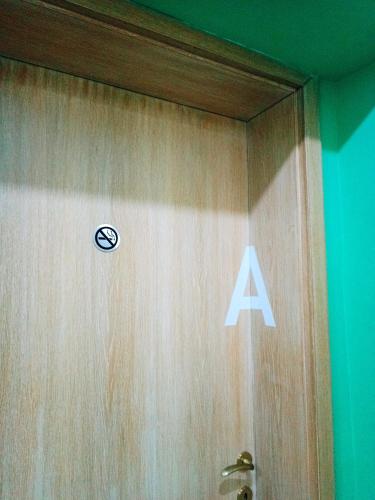 a door with a sign on it in a room at Hostel Central Skopje in Skopje