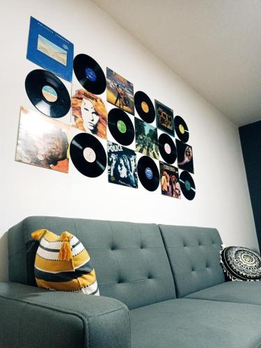a living room with a couch and records on the wall at Hostel Central Skopje in Skopje