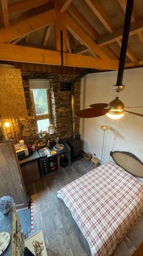 a bedroom with a bed and a desk in a room at Casa da Ribeira- Riverside Retreat by Paiva River Beach in Arouca