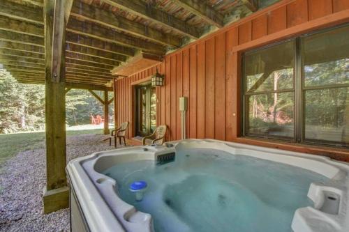 a large jacuzzi tub in a house at Spacious log cottage Resort access in Lac-Superieur