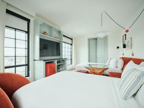 a living room with a couch and a table at Virgin Hotels New Orleans in New Orleans