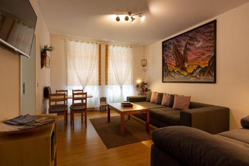 a living room with a couch and a table at Ferienwohnung-am-Auensee in Leipzig