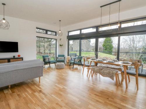 a living room with a table and a couch at Coorie In in Aberfeldy