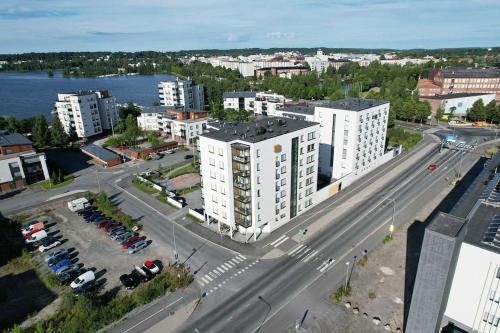 an aerial view of a city with a road and buildings at Valoisa huoneisto parvekkeella ja järvinäköalalla in Hämeenlinna