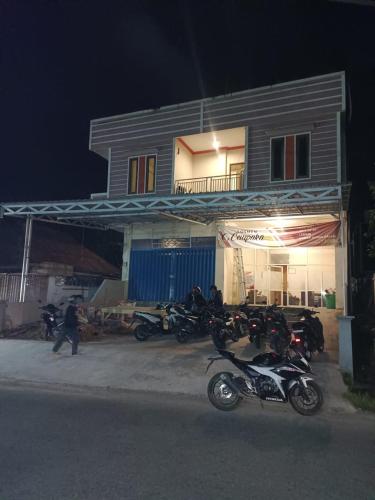 un gruppo di motocicli parcheggiato di fronte a un edificio di Losmen cempaka a Sibengkok