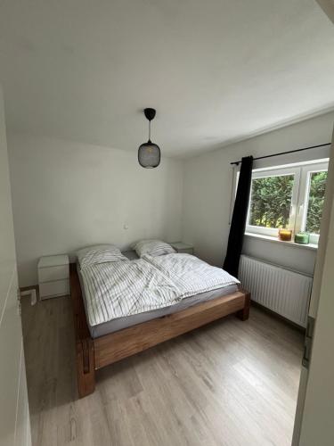 a bedroom with a bed in a room with a window at Apartment Ida in Viereth-Trunstadt