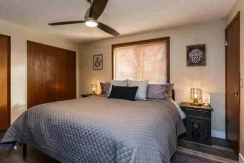 a bedroom with a bed and a ceiling fan at #StayInMyDistrict Eclectic Boise Townhouse near St Als in Boise