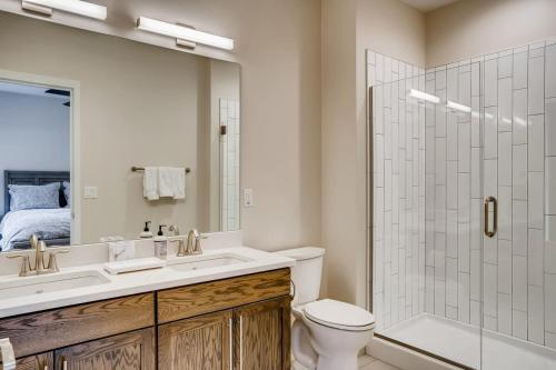 a bathroom with a toilet and a sink and a shower at Rambler's Retreat Sleeps 8 Lakefront View in Georgetown