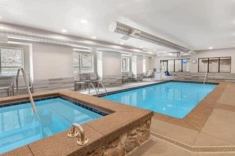 a large swimming pool in a hotel room at Rambler's Retreat Sleeps 8 Lakefront View in Georgetown