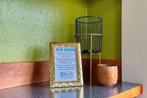 a sign sitting on a table with a vase at #StayinMyDistrict Historic Apartment Near Downtown in Coos Bay