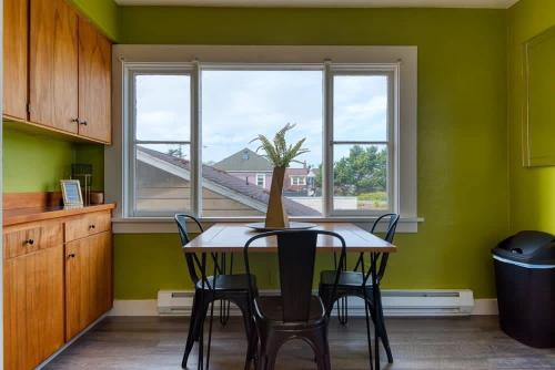 a kitchen with a table and chairs and a window at #StayinMyDistrict Historic Apartment Near Downtown in Coos Bay