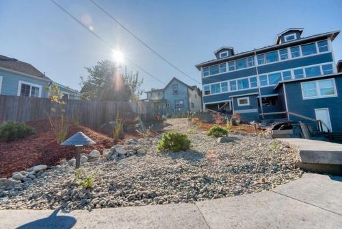 a garden in a yard in front of a house at #StayinMyDistrict Historic Apartment Near Downtown in Coos Bay