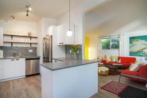 a kitchen and living room with a refrigerator and a couch at #StayinMyDistrict Modern Mid-Century Retreat in Beaverton