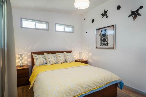 a bedroom with a bed with a yellow bedspread at #StayinMyDistrict Modern Mid-Century Retreat in Beaverton