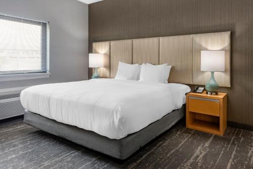 a large white bed in a hotel room at Amwell Suites in Ukrainian Village