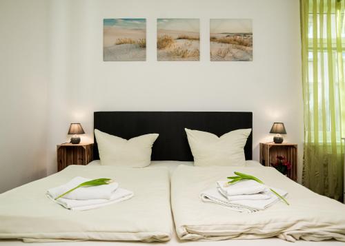 a bedroom with a bed with two towels on it at Apartmenthaus Sternstraße in Dresden