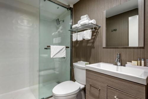 a bathroom with a toilet and a sink and a shower at Amwell Suites Somerset/Bridgewater 