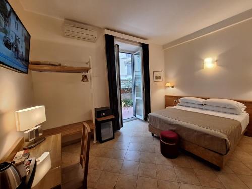 a bedroom with a bed and a large window at Hotel Principe Eugenio in Rome