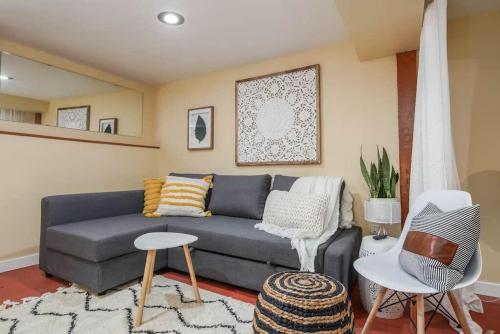 a living room with a blue couch and chairs at #StayInMyDistrict Woodlawn Eclectic -Walk to Dekum in Portland