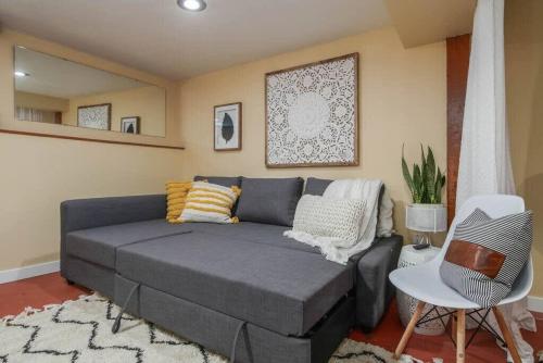 a living room with a gray couch and a chair at #StayInMyDistrict Woodlawn Eclectic -Walk to Dekum in Portland