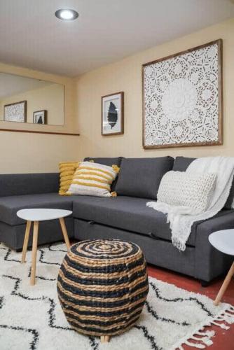 a living room with a blue couch and two tables at #StayInMyDistrict Woodlawn Eclectic -Walk to Dekum in Portland