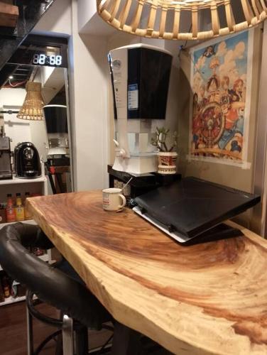 a wooden table with a laptop on top of it at The King's Cabin - Baguio in Itogon