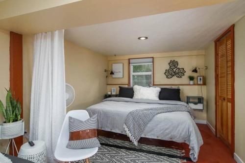 a bedroom with a large bed and a window at #StayInMyDistrict Woodlawn Eclectic -Walk to Dekum in Portland