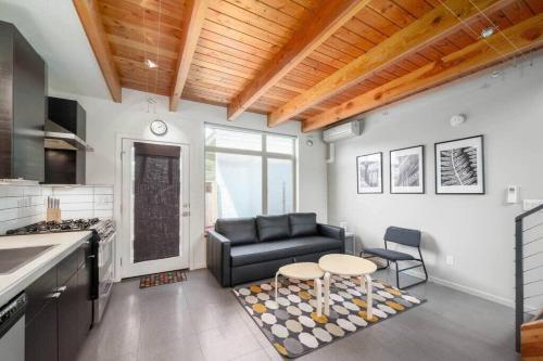 a living room with a couch and a table at #StayinMyDistrict Buckman Open Loft-Style Townhome in Portland