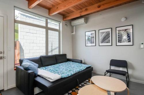 a living room with a couch and a table at #StayinMyDistrict Buckman Open Loft-Style Townhome in Portland