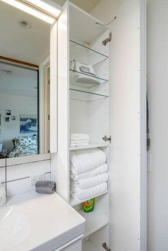 a bathroom with a sink and a mirror and towels at #StayinMyDistrict Buckman Open Loft-Style Townhome in Portland