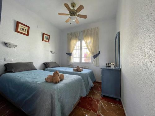 a bedroom with two beds with teddy bears on them at Traditional Villa with Private Pool SM591 in San Miguel de Salinas