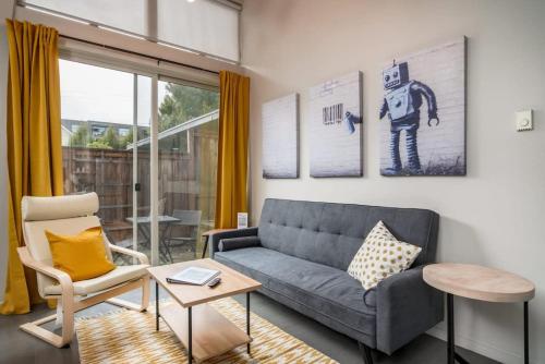 a living room with a couch and a chair at #StayInMyDistrict Buckman Bright Spacious Townhome in Portland