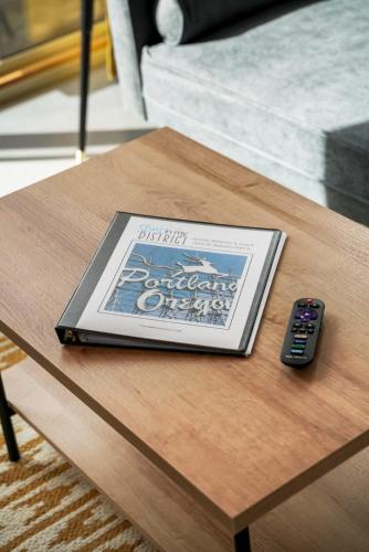 a book on a table next to a remote control at #StayInMyDistrict Buckman Bright Spacious Townhome in Portland