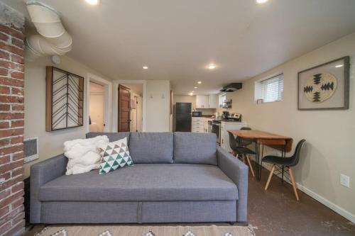 a living room with a blue couch and a kitchen at #StayinMyDistrict Pendelton Place Walk to Mt Tabor in Portland