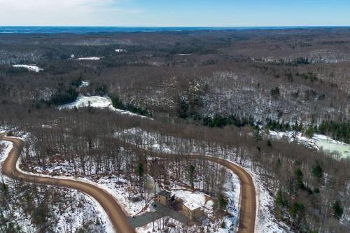 an aerial view of a winding road in the woods at Chalet Élios in Brownsburg