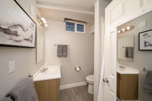 a white bathroom with a sink and a toilet at #StayInMyDistrict Piedmont Near Parks and Shopping in Portland