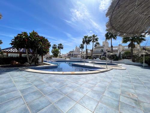 basen z palmami i budynkami w obiekcie Botanical 2 Bedroom Bungalow with Com Pool VM33 w mieście Orihuela