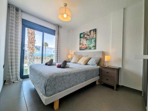 a bedroom with a bed and a large window at Modern 2 Bed Apt in La Zenia LZ9 in Orihuela