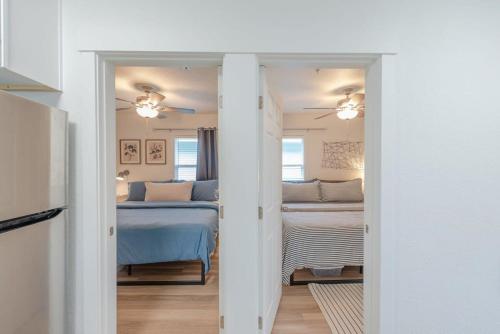 a room with a bedroom with a bed and a room with a bed sqor at #StayInMyDistrict Indigo Cottage Coos Bay in Coos Bay