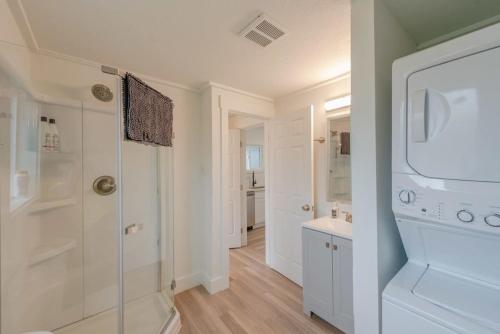 a bathroom with a walk in shower and a sink at #StayInMyDistrict Indigo Cottage Coos Bay in Coos Bay