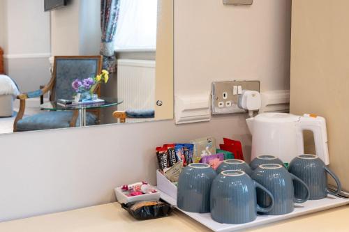 a group of blue vases on a shelf in front of a mirror at The Lanes Hotel in Brighton & Hove