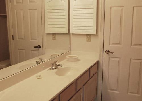 a bathroom with a sink and a mirror at Heron Lake 3232 in North Myrtle Beach