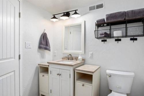 a white bathroom with a sink and a toilet at #StayinMyDistrict Twin Falls Pendleton Chic Suite in Twin Falls