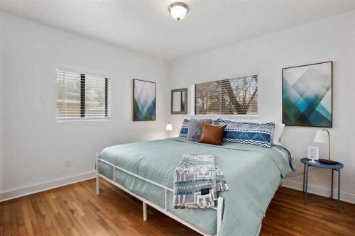 a bedroom with a bed and two windows at #StayinMyDistrict Twin Falls Spanish-Boho Getaway in Twin Falls