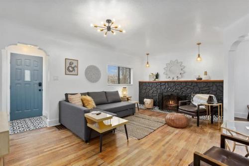 a living room with a blue couch and a fireplace at #StayinMyDistrictTwinFalls Tudor in Twin Falls