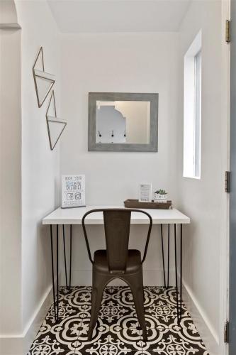 a table and a chair in a room at #StayinMyDistrictTwinFalls Tudor in Twin Falls