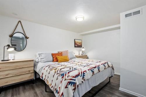 a white bedroom with a bed and a mirror at #StayinMyDistrictTwinFalls Tudor in Twin Falls