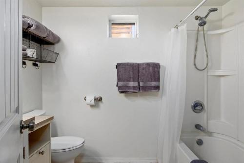 a white bathroom with a toilet and a shower at #StayinMyDistrictTwinFalls Tudor in Twin Falls