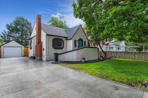 a white house with a fence and a yard at #StayinMyDistrictTwinFalls Tudor in Twin Falls